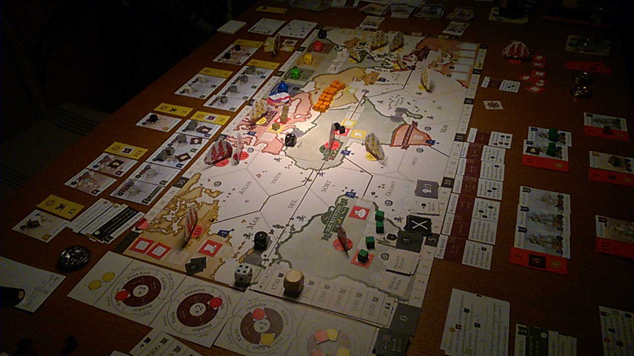 The full game board of the Admiralen board game in the middle of a play test session with card of both players at each side.
